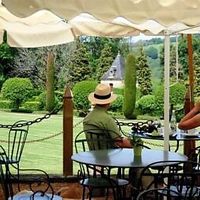 The terrace overlooks the gardens of Eyrignac at Côté Jardin in Salignac-eyvigues