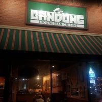 Outside of store in a strip mall with small parking lot at Bandung Indonesian Restaurant in Madison