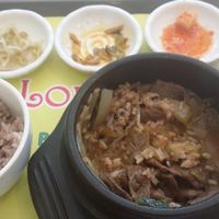 Bulgoggi  vegan jiggae (stew) with mixed rice and several side dishes, half eaten.  
 at Loving Hut Gangnam-gu - 러빙헛 in Seoul