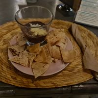 Corn chips and mashed beans topped with cheese was on the house. at Mantura Bistro Garden in Chetumal