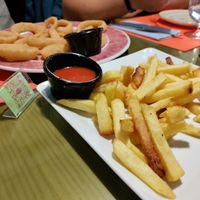 Patatas bravas with very spicy sauce! And onion rings at Piccolo in Cuenca