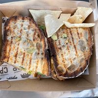 Toasted sourdough, grilled tamari tofu, avocado, tomato, spinach, hummus, vegan smokey mayo & dukkah. Small side of homemade chips. at Cali Press in Double Bay