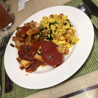 Vegan tofu scramble, polenta and breakfast potatoes with fresh juice  at Wynn Hotel - The Buffet in Las Vegas