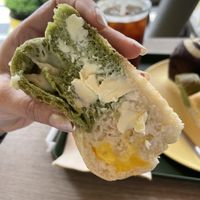 Spinach bread with vegan cheese filling and vegan butter on top   at Vegan Veganing in Seoul