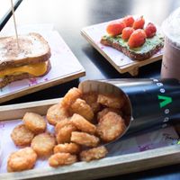 Avocado toast, tater tots, bacon egg & cheese & chocolate shake at SoBe Vegan in Miami Beach