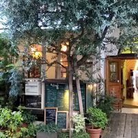 Street frontage covered in foliage. Outdoor seating/ smokers area behind.   at Modernark in Kobe