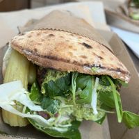 Green goddess pita 🥙  We ordered take away as inside was busy but then found an empty table outside to eat at  at Jimmy's Falafel in Sydney