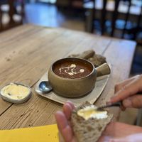 Tomato and wild garlic soup served with seeded sourdough!   at Figaro in Wingerworth