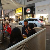 Sits outside at Veganista Ice Cream XII in Vienna