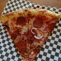 Slice is easier to handle if they cut it in half. Nice thin crust. at The Hungry Sasquatch in Vancouver