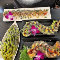 Red Dragon Roll, Dragon Roll, Volcano Roll, & Spicy Garlic Edamame. at Vegan Castle in Long Beach
