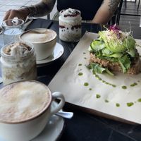 Overnight Oats und Avocado Sandwich + Flat white with Oatmilk 👌🏼  at Bakery Kafeneio in Limassol