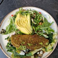 Vegan chickpea based omelette with feta cheese inside and greens. at Bakery Kafeneio in Limassol
