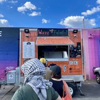 People standing in line to order some great vegan falafel based food  at Wazzup Falafel in Preston