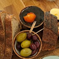 Olives, lemon hummus, black bean pate, smoked nuts at Hendersons in Edinburgh