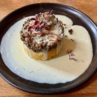 Hendersons Haggis with root mash, whisky tarragon cream + caramelised red onion  at Hendersons in Edinburgh