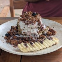 Quinoa almond flour pancakes with granola and coconut yogurt. So good! at Gracias Vida in La Guajira