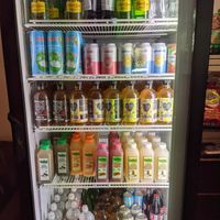 Assortment of chilled juices, still and mineral waters, kombucha, soda and other chilled beverages available in this fridge. at Kilovolt Coffee in Oakland