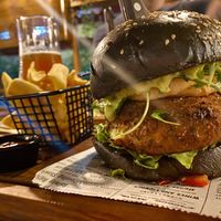 Poppea burger with zucchini falafel, fried onion rings, guacamole sauce, lettuce  at Agrippina Street Food in Pula