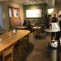 Inside: note community table and separate tables. at Le Pain Quotidien - Madison Ave in New York City