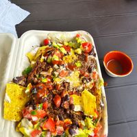 Nachos supreme with hot sauce at Moksha in Rincon