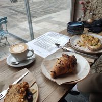 Vegan banana bread, chocolate croissant, avocado&hummus bread, oat cappuccino, & blue chai latte at Nook in Vienna
