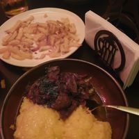 Mushroom stew with polenta, and chips. at Caru' cu Bere in Bucharest