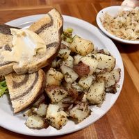 hidden tofu/veggie scramble with potatoes, sauerkraut, and toast with a questionable portion of vegan butter!  at Morning Glory Cafe in Eugene