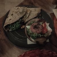 Piadina with Harissa Paste 🌶️, Arugula 🥬 and Grilled Aubergine 🍆 + Side Salad 🥗 at Esfigueral in Ibiza