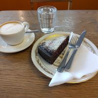Small cappuccino with oatmilk and vegan fruit-berries-chocolate cake. at De Bakkerswinkel - Kahvalti in Amsterdam
