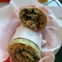 Chickpea shawarma wrap and a vampire slayer juice in the background   at Juicy's Wellness Cafe in Cookeville