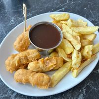 Chips and battered sausages at Neptune Fish Restaurant in Seahouses