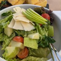 Fruity sensation salad with sliced vegan cheese at 5SENSES Restaurant in Santorini
