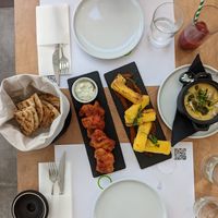 Left to right: pita, tomato fritters, saganaki cheese, fava at 5SENSES Restaurant in Santorini