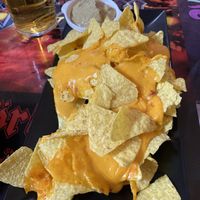 Nachos con salsa de queso cheddar y guacamole caseros at Faroles Taberna Rock in Valladolid