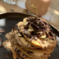 Vegan pancakes with PB, banana and chocolate flakes  at Almond in Paros