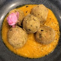 Chickpea and aubergine balls on a bed of pumpkin cream  at il Bosco delle Galline Volanti in Barolo