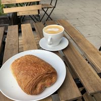 pain au chocolat and latte at Massolit Books & Café in Krakow
