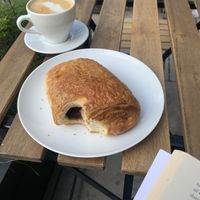 pain au chocolat and latte  at Massolit Books & Café in Krakow