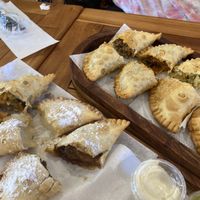 Left: sweet potato and vegetables savory, pineapple coconut dessert, apple pie dessert. Right: beefless savory, eggplant savory, vegetables savory, plantain cheese savory    at Franchesca's Empanadas Cafe in Baltimore