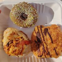 Pepperoni, cheese bread, pistachio raised donut, and chocolate croissant. at Timeless Coffee - Webster in Oakland