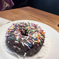Rainbow sprinkle chocolate donut  at Timeless Coffee - Webster in Oakland