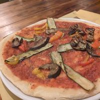 Friendly service, happy to alter a vegetarian pizza to make it vegan without the cheese for only €8.50 which is good value in Lake Como when you have a beautiful view of the lake at Lake Como Beach Hostel in Domaso