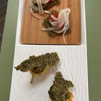 "Mise en bouche" - Pickled fennel and watermelon on homemade seed cracker.  at Iris Café in Bardigues