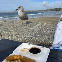 Chips, battered sausage and gravy   at The Harbour Chippy in Newquay