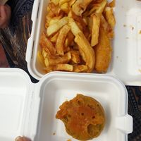Chips, battered sausage and mushy peas fritter at The Harbour Chippy in Newquay