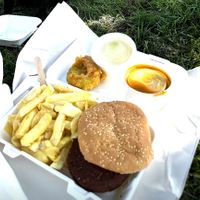 Chips, Vegan burger with lettuce. Pea fritter, curry sauce and pickled onion. £10.60 All tasty!   at The Harbour Chippy in Newquay