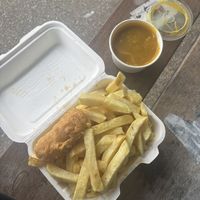 Tiny battered sausage, chips and curry sauce  at The Harbour Chippy in Newquay