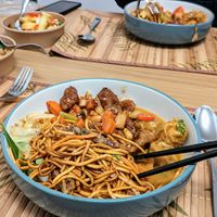 Chow Mein, Crispy Duck Chow Mein, Kung Pow Chicken, Malaysian Tofu Curry, Popcorn Tofu, and chips at Cheungs Vegan Kitchen in Bristol