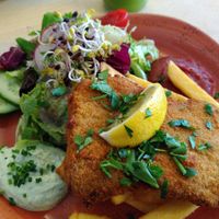 Vegan schnitzel with side salad, vegan herb sauce and topped with parsley and fresh lemon. at Max Pett in Munich